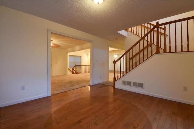 interior space featuring hardwood / wood-style floors and a textured ceiling