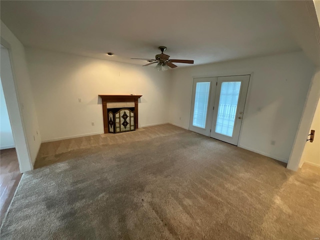 unfurnished living room with ceiling fan and light colored carpet