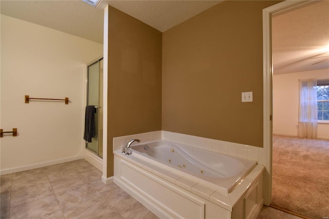 bathroom featuring a textured ceiling, separate shower and tub, and ceiling fan