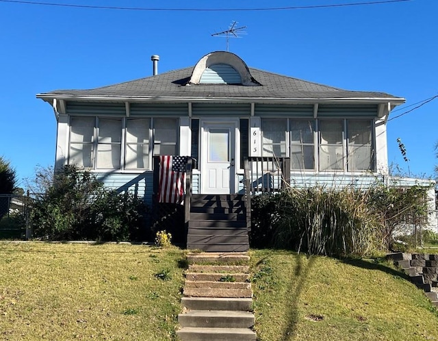 bungalow-style home with a front lawn