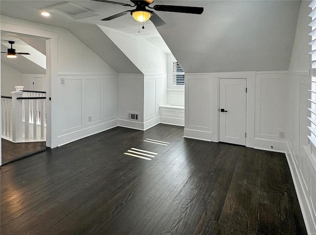 bonus room with vaulted ceiling, ceiling fan, and dark wood-type flooring