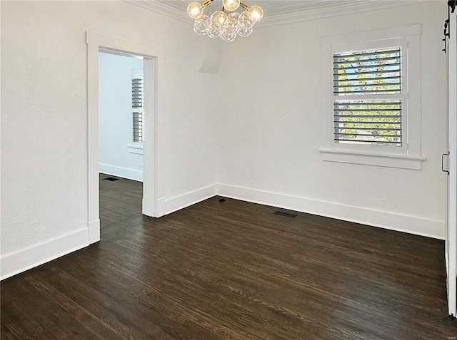 spare room with crown molding, dark hardwood / wood-style floors, and a notable chandelier