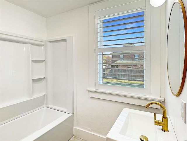 bathroom featuring shower / tub combination, vanity, and a healthy amount of sunlight