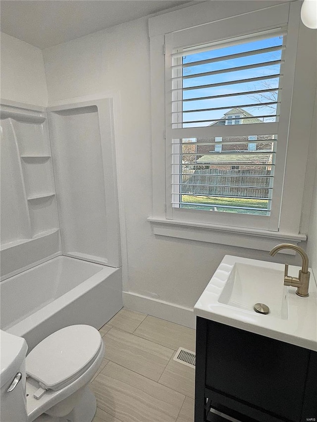 full bathroom featuring vanity, shower / tub combination, and toilet