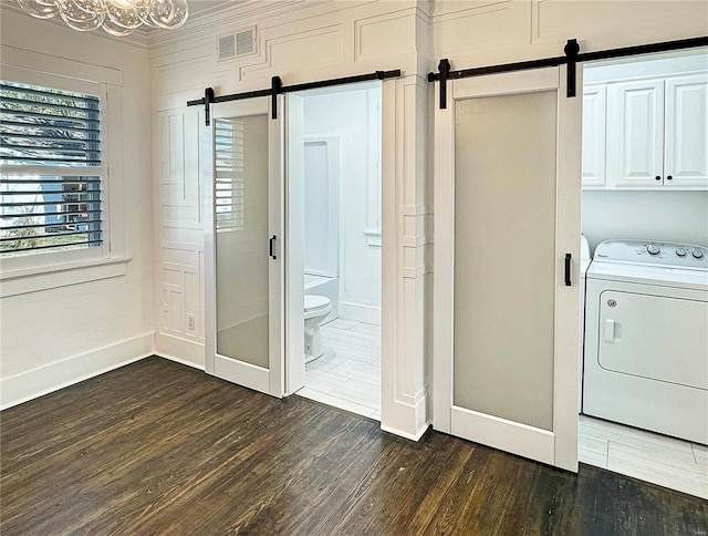 laundry area with washer / clothes dryer, cabinets, dark hardwood / wood-style floors, and a barn door