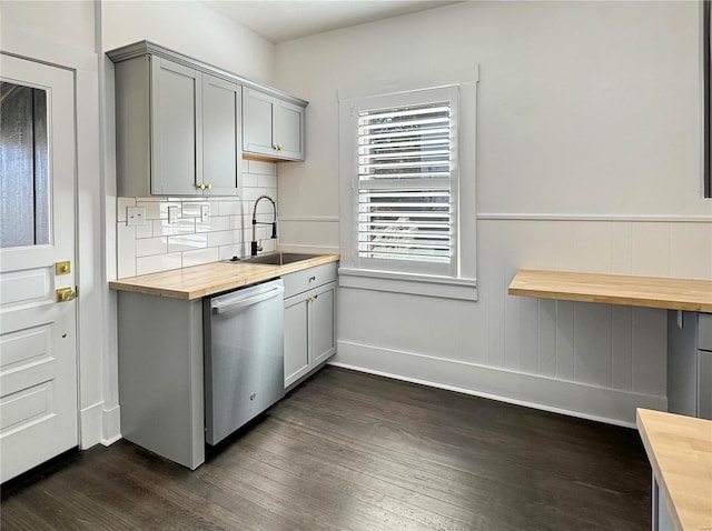 kitchen with dishwasher, sink, wood counters, dark hardwood / wood-style flooring, and gray cabinets