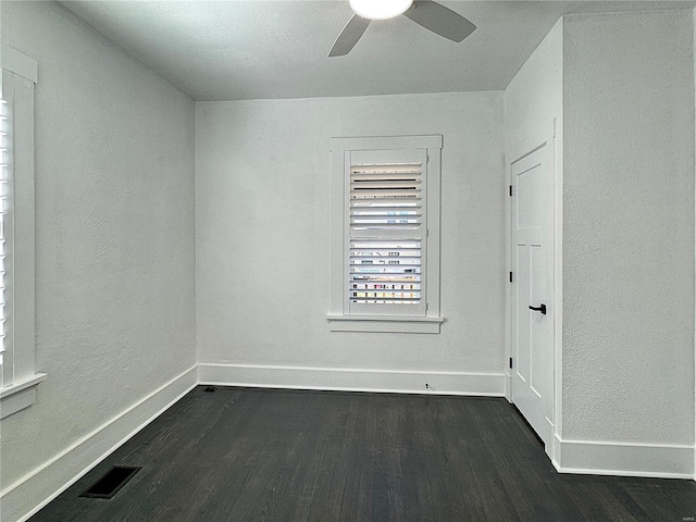 unfurnished room featuring ceiling fan and dark wood-type flooring