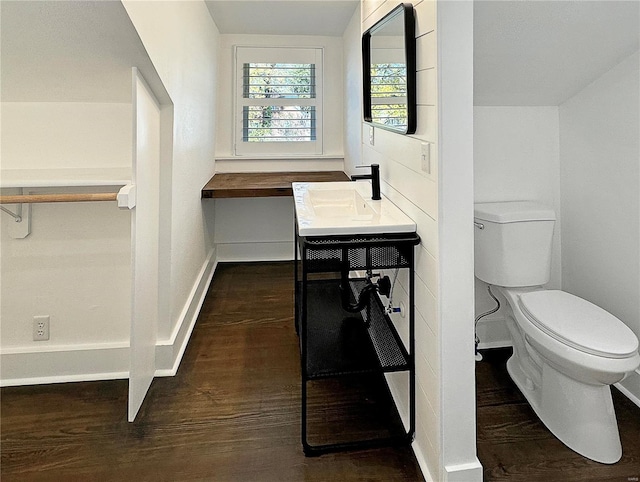 bathroom with toilet, vanity, and hardwood / wood-style flooring