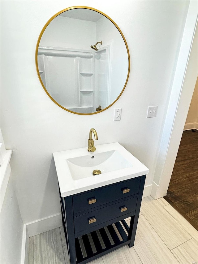 bathroom featuring vanity, walk in shower, and hardwood / wood-style flooring