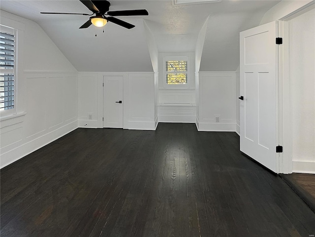 additional living space with vaulted ceiling, ceiling fan, and dark wood-type flooring