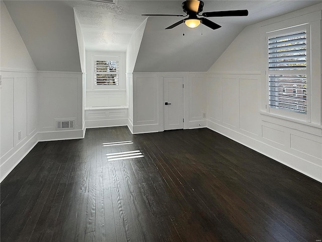 bonus room featuring dark hardwood / wood-style flooring, a wealth of natural light, and lofted ceiling