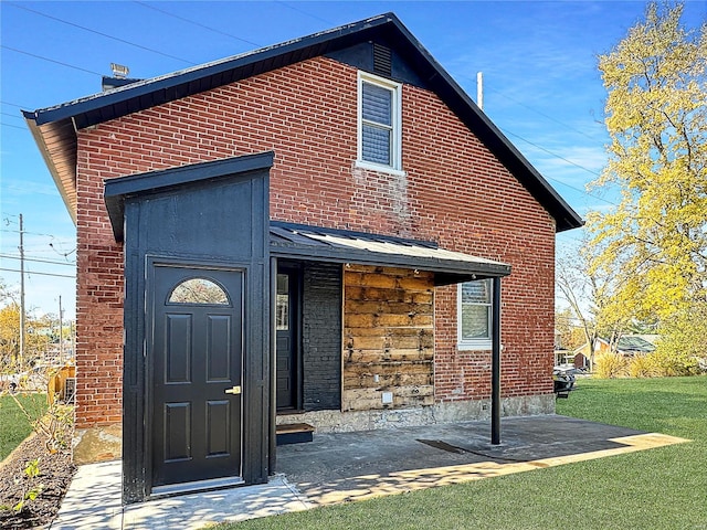 back of house with a lawn