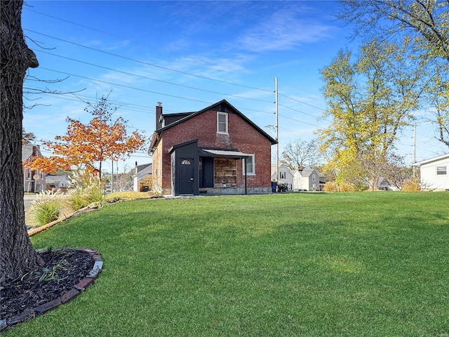 back of property featuring a yard