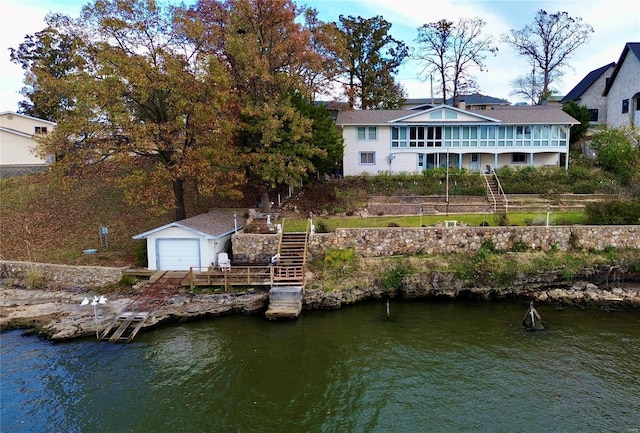 rear view of property featuring a deck with water view