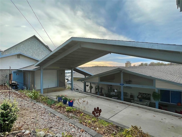 view of property exterior featuring a garage and a carport