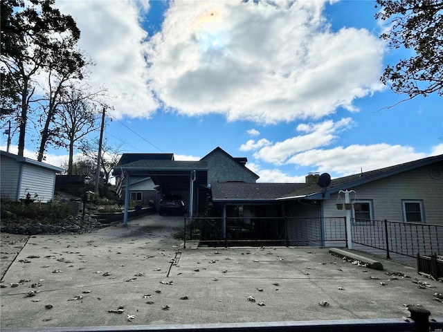 rear view of house featuring a carport