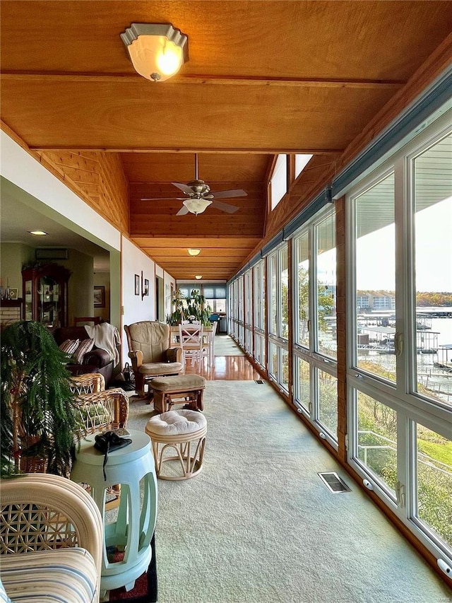 sunroom with vaulted ceiling, wooden ceiling, and ceiling fan