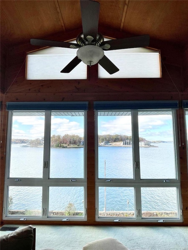 interior space with a water view and ceiling fan