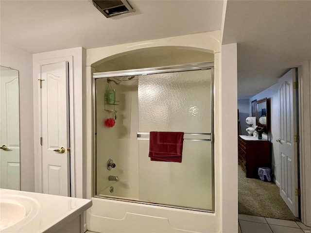 bathroom with vanity, tile patterned floors, and enclosed tub / shower combo