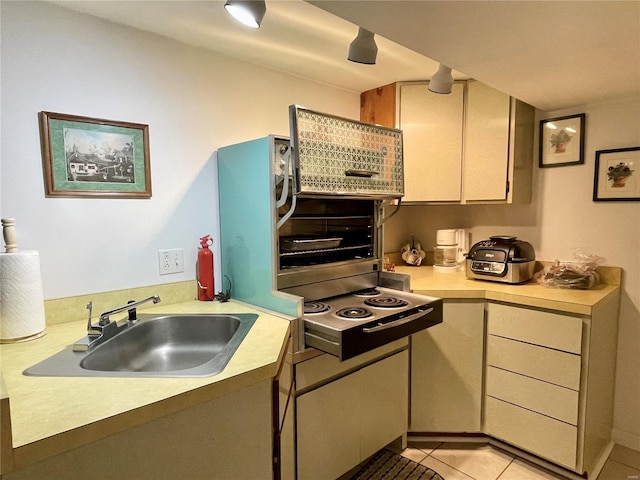 kitchen featuring light tile patterned floors and sink