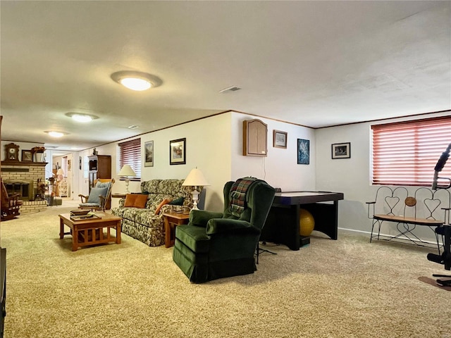 living room with carpet and a fireplace