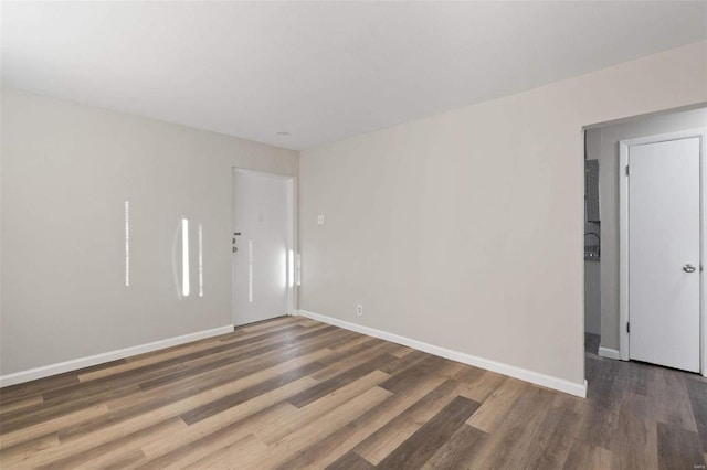 empty room with dark wood-type flooring