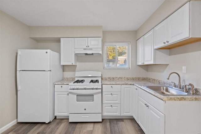 kitchen featuring white appliances, white cabinets, hardwood / wood-style flooring, and sink