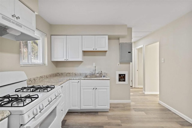 kitchen featuring electric panel, gas range gas stove, white cabinets, and light wood-type flooring