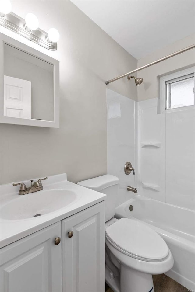 full bathroom featuring vanity, toilet, and washtub / shower combination