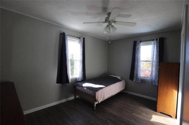 bedroom featuring ceiling fan, dark hardwood / wood-style floors, and crown molding