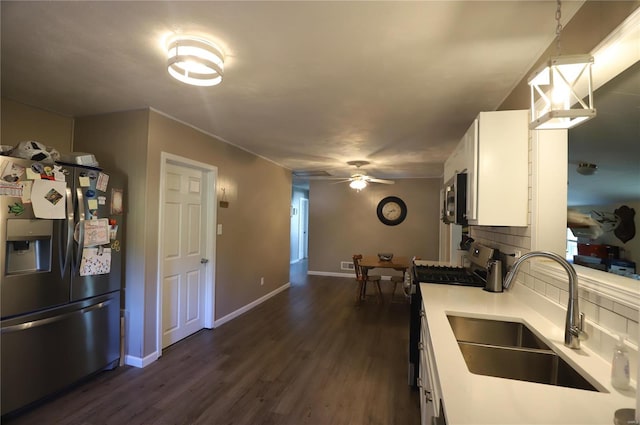 kitchen featuring stainless steel appliances, white cabinetry, backsplash, dark hardwood / wood-style flooring, and sink