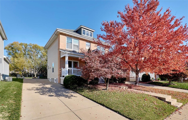 view of front of property with a porch, central AC unit, and a front lawn