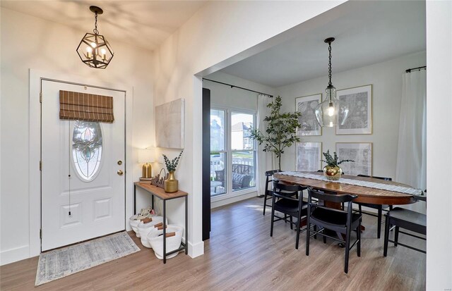 entryway with a notable chandelier and hardwood / wood-style flooring