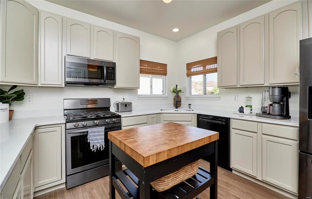 kitchen featuring sink, stainless steel appliances, and light hardwood / wood-style floors