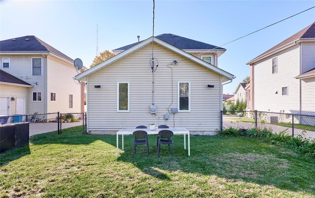 rear view of house featuring a lawn