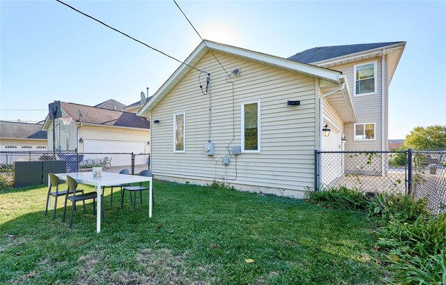 rear view of property featuring a yard