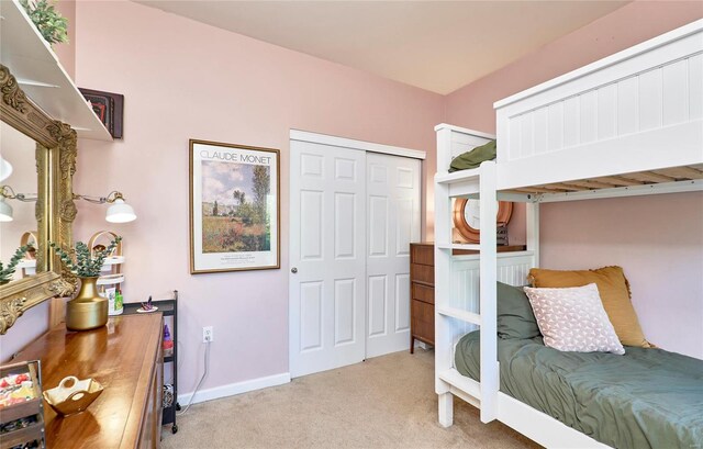 bedroom with a closet and light colored carpet