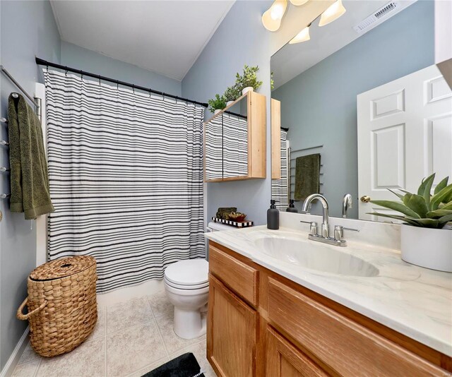 bathroom featuring tile patterned flooring, vanity, and toilet