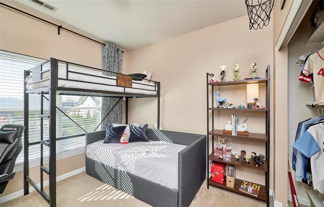 bedroom with light carpet and multiple windows