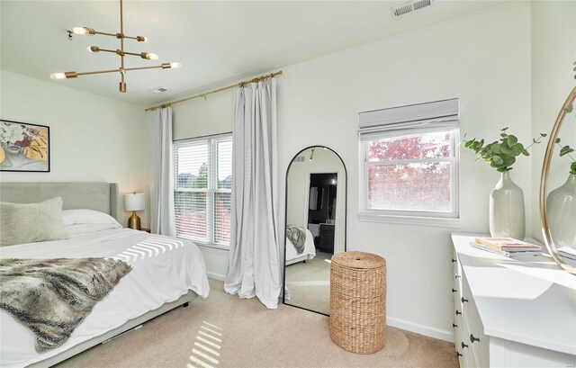 carpeted bedroom with a chandelier and multiple windows