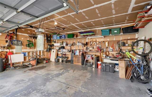 garage featuring a workshop area and a garage door opener