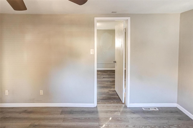 empty room featuring ceiling fan and wood-type flooring