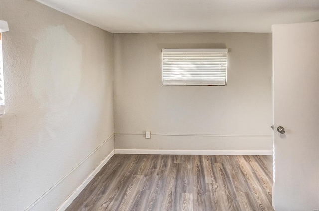 spare room with dark wood-type flooring