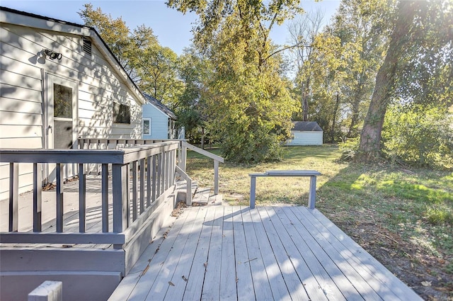 wooden deck featuring a yard and a shed