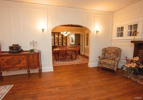 living area featuring hardwood / wood-style floors and a notable chandelier