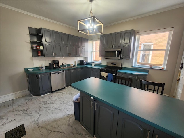 kitchen with crown molding, hanging light fixtures, appliances with stainless steel finishes, and an inviting chandelier