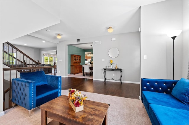 living room with wood-type flooring and a notable chandelier