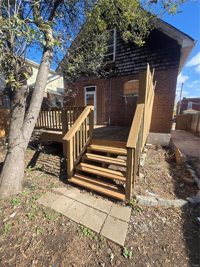 back of property featuring a wooden deck