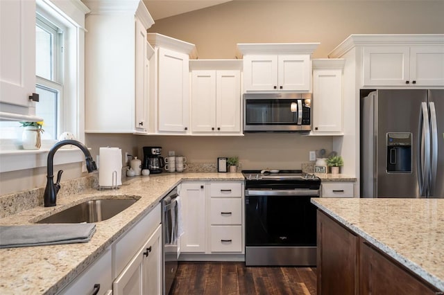 kitchen featuring dark hardwood / wood-style floors, white cabinetry, sink, and appliances with stainless steel finishes