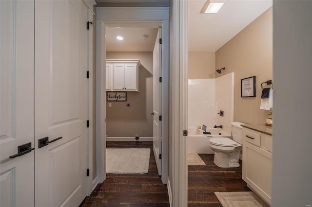 full bathroom featuring hardwood / wood-style floors, vanity, toilet, and shower / bathtub combination